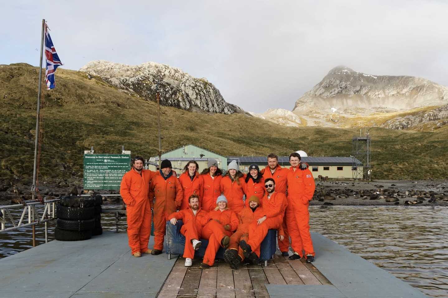 A group of people standing in front of the Bird Island research station