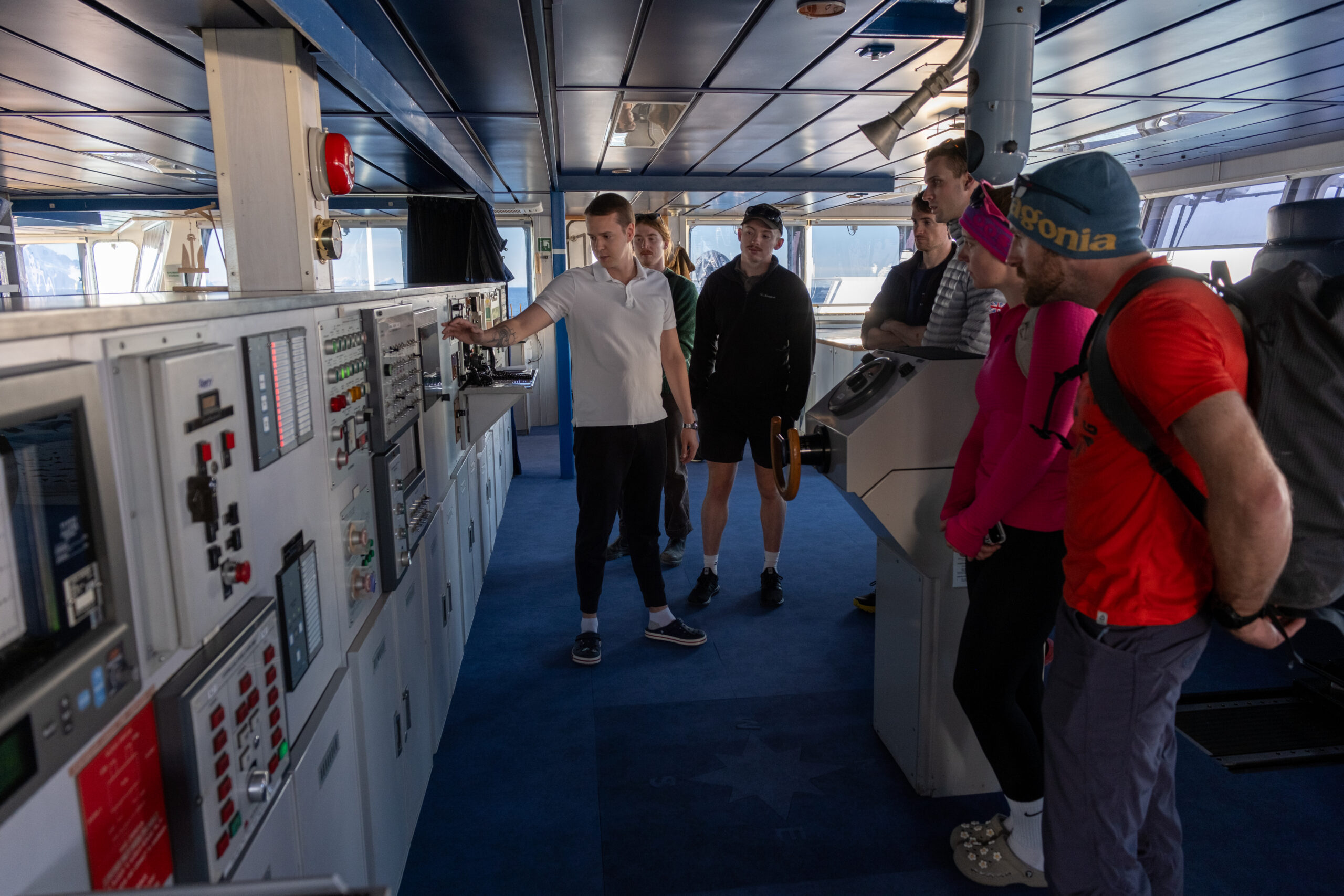 a group of people facing a wall