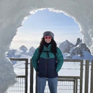 A woman standing in front of a mountain