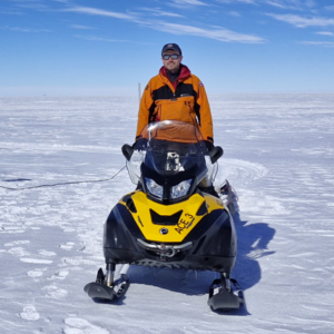 A man standing on top of a snow covered slope