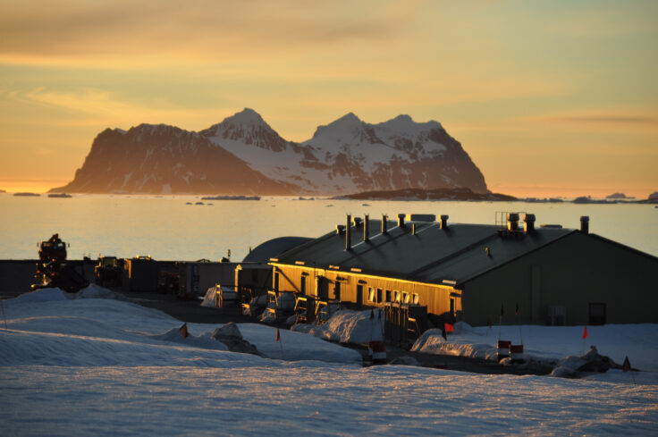 A boat parked on the side of a snow covered mountain