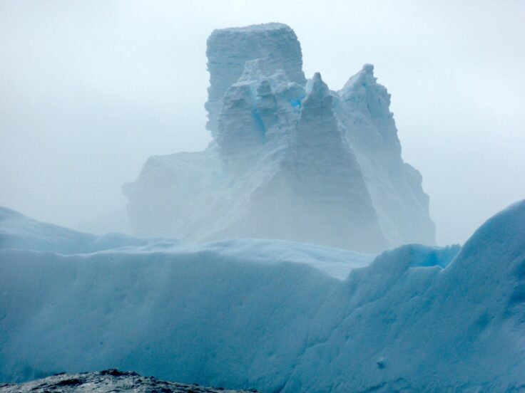 Giant iceberg A76a looming above ocean in mist