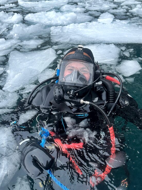 A person that is sitting in the snow
