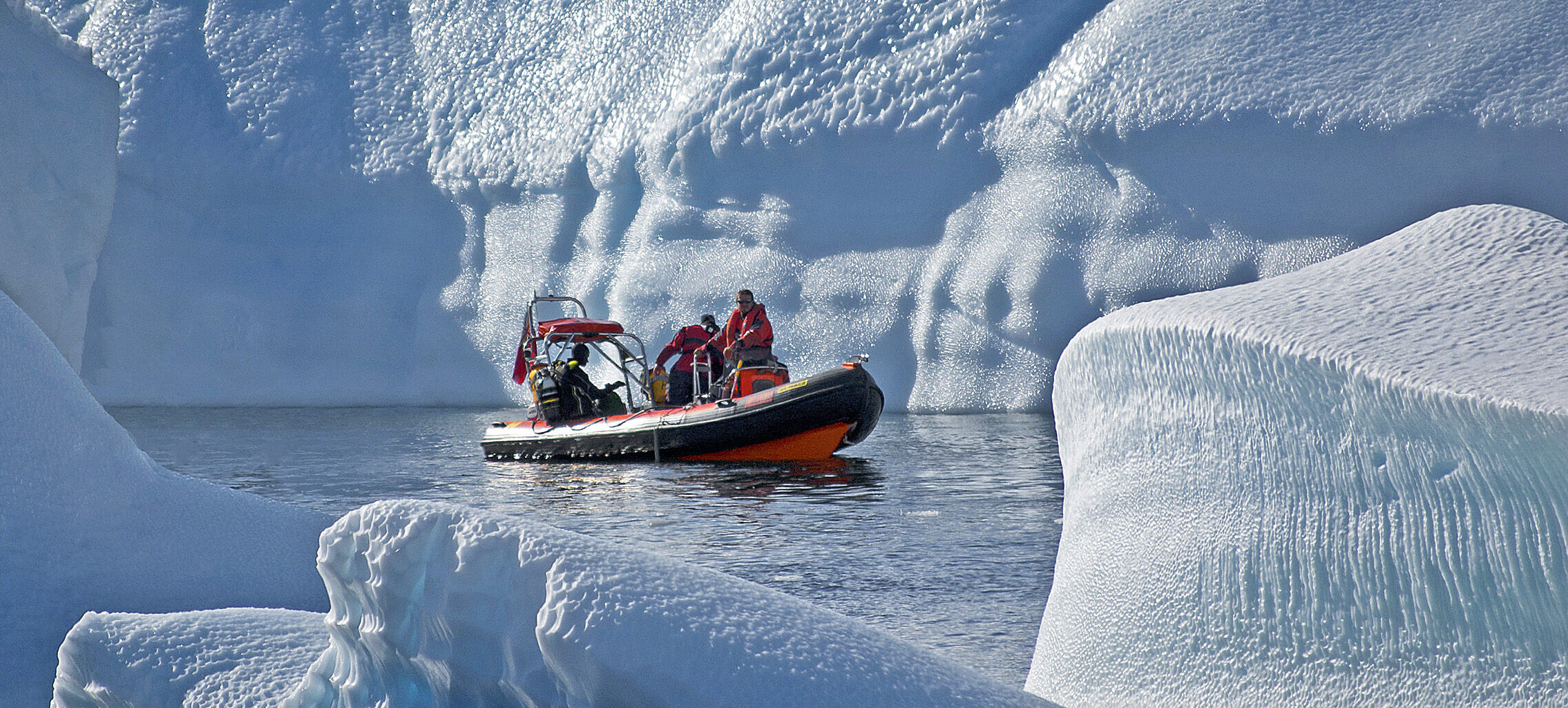 A man riding on the back of a boat in the water