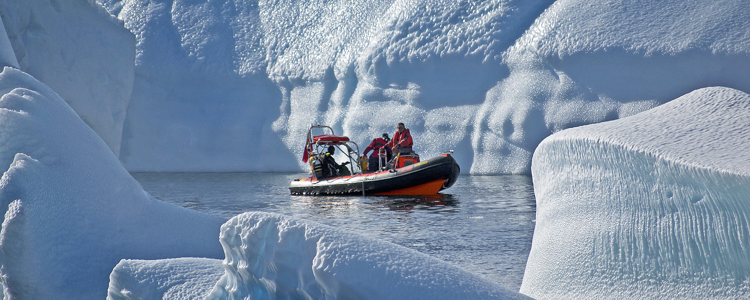 A man riding on the back of a boat in the water