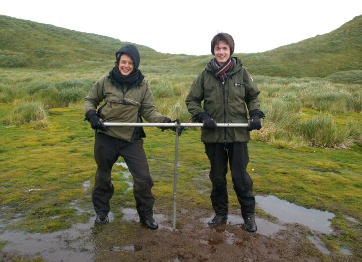 A man standing on a grassy hill