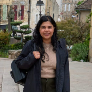 A person standing on a sidewalk