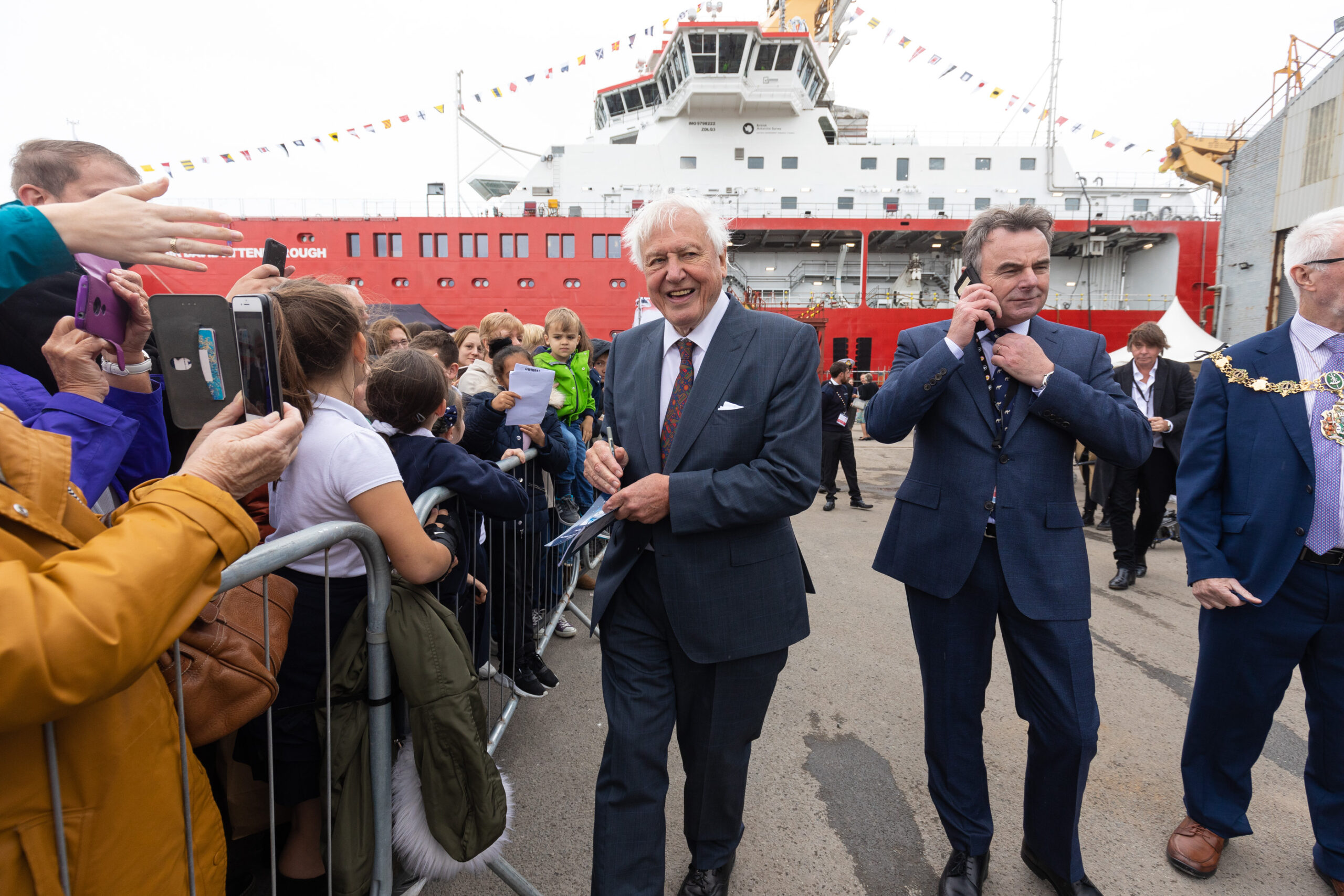 David Attenborough et al. standing in front of a crowd