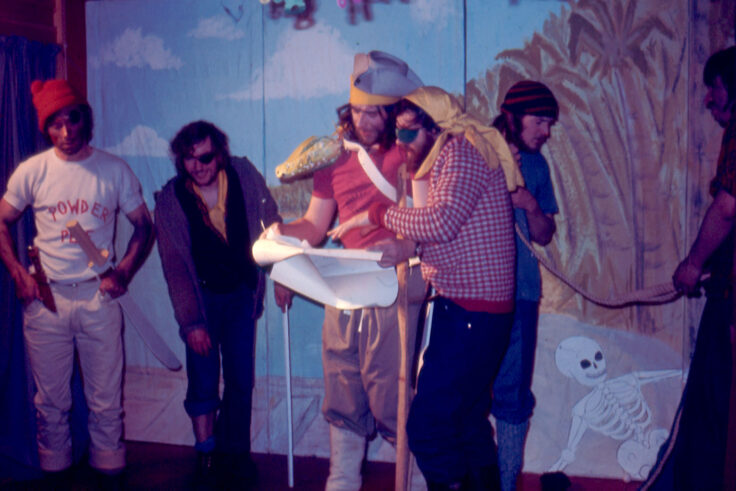 A group of people dressed as pirates putting on a play.