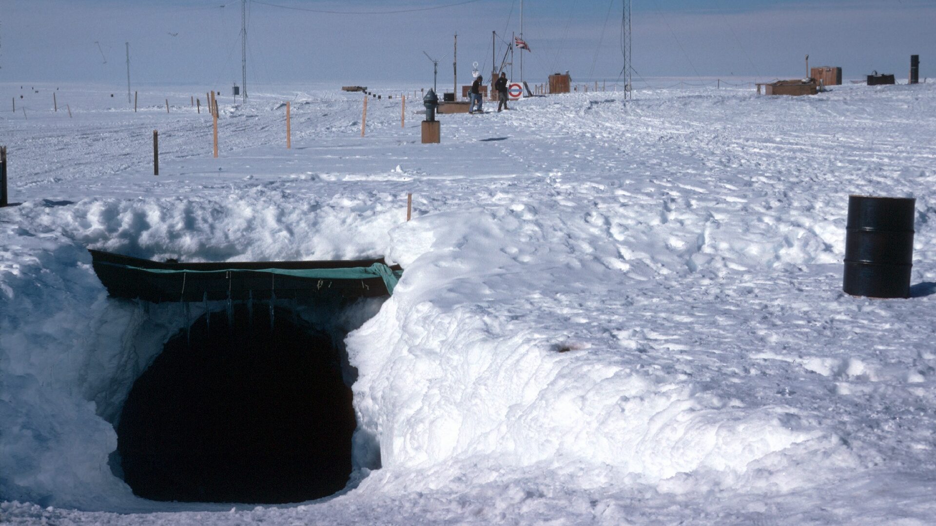 A tunnel entrance into a station complex buried under snow.