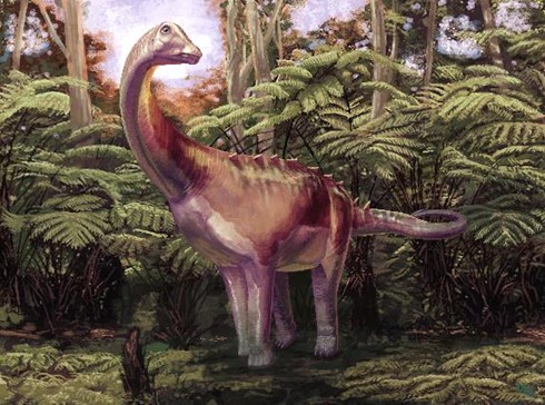 A reconstruction of a dinosaur standing next to a palm tree