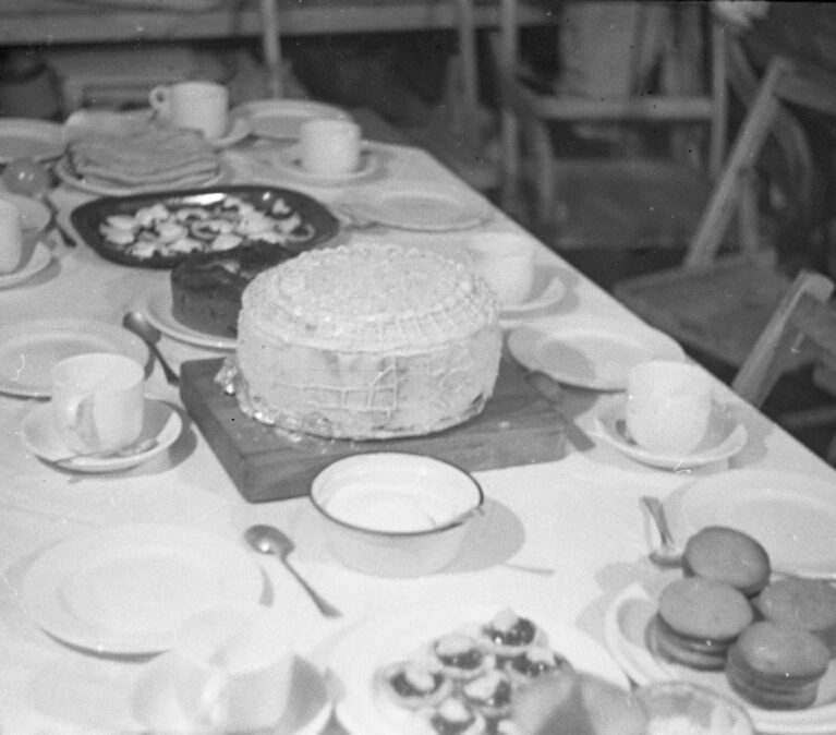 A dining table with a cake on a plate
