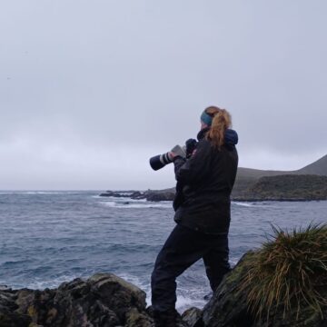 A man standing next to a body of water