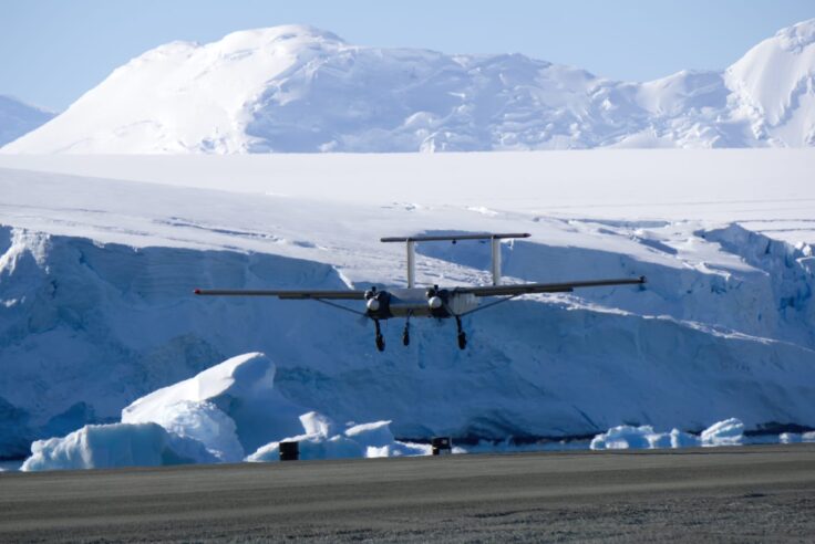 A man flying through the air on a snow covered mountain