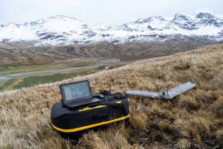 A plane sitting on top of a grass covered field