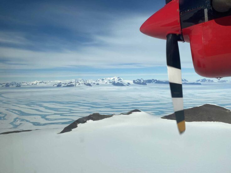 Onboard an aeroplane flying over an ice field.