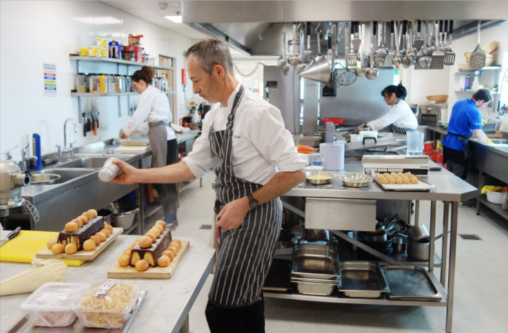 A person cooking in a kitchen preparing food