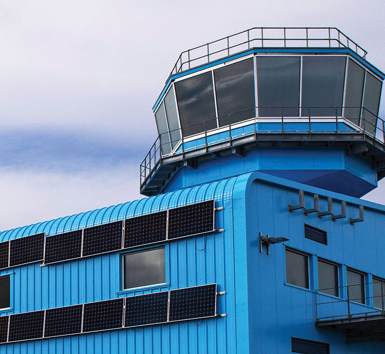 Blue building against a cloudy sky