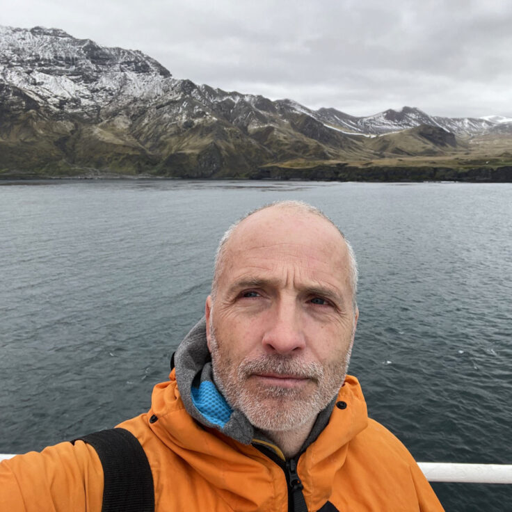 A man in front of a body of water