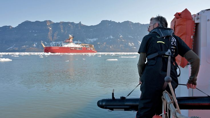 A man standing next to a body of water
